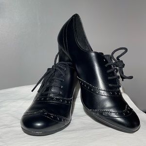 Black leather like tied up women’s dance shoes